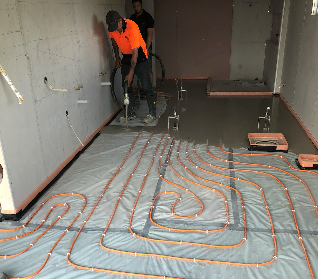 Concrete worker pours floor levelling compound