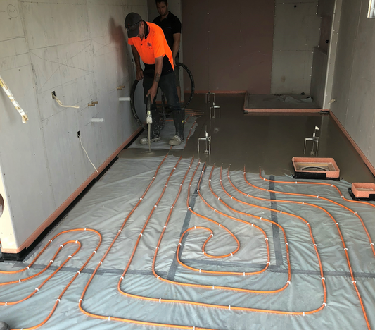 Concrete worker pours floor levelling compound